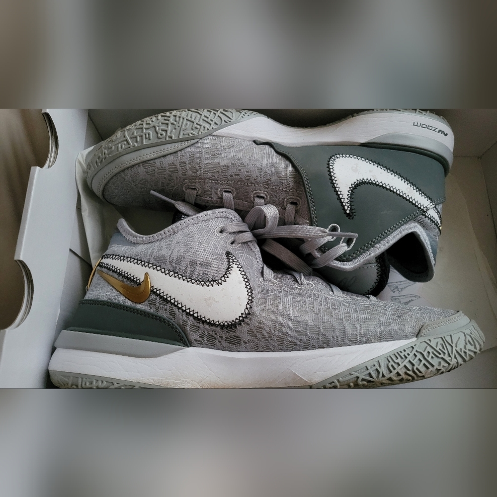 Gray and White Nike Sneakers with Gold Accent
